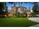 Charming two-story home featuring a stone turret, manicured lawn and professional landscaping at 11106 Coniston Way, Windermere, FL 34786