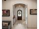 Elegant foyer featuring an arched doorway, tiled flooring, and decorative accents at 11106 Coniston Way, Windermere, FL 34786