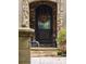 Close-up of the front door with stone archway, decorative wreath, and potted plants at 11106 Coniston Way, Windermere, FL 34786