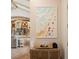 Hallway displaying beach-themed artwork and leading to an open-concept living space with kitchen beyond at 11106 Coniston Way, Windermere, FL 34786