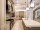Spacious kitchen with stainless steel appliances, large center island, and custom cabinetry at 11106 Coniston Way, Windermere, FL 34786