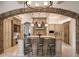 Open concept kitchen with large island, granite counters, custom cabinets, and pendant lighting at 11106 Coniston Way, Windermere, FL 34786