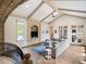 Bright living room featuring vaulted ceilings, herringbone floors, a cozy sofa, and a custom entertainment center at 11106 Coniston Way, Windermere, FL 34786