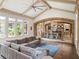 Spacious living room boasting vaulted ceilings, a comfortable sofa, and large windows overlooking the yard at 11106 Coniston Way, Windermere, FL 34786