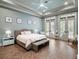 Serene main bedroom featuring neutral tones, tray ceilings, and french doors leading to the outdoors at 11106 Coniston Way, Windermere, FL 34786