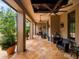 Inviting outdoor living space featuring an outdoor kitchen and dining, comfortable seating, and a tropical garden view at 11106 Coniston Way, Windermere, FL 34786