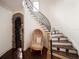 Elegant staircase with curved wrought iron railing and dark wood treads at 11106 Coniston Way, Windermere, FL 34786