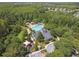 Aerial view of the community pool, clubhouse, playground, and surrounding wooded area at 1275 Shallcross Ave, Orlando, FL 32828