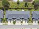 Aerial view of townhouses showing roof lines, driveways and landscaping in a well maintained community at 1275 Shallcross Ave, Orlando, FL 32828