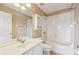 Bright bathroom featuring a shower-tub combo, a white vanity with sink, and a mirrored wall cabinet at 1275 Shallcross Ave, Orlando, FL 32828