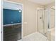 Modern bath with tiled shower and view into bedroom at 1275 Shallcross Ave, Orlando, FL 32828