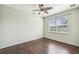 This light and airy bedroom has a ceiling fan and large window at 1275 Shallcross Ave, Orlando, FL 32828