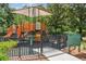 Community playground with a safety fence and signage for visitors at 1275 Shallcross Ave, Orlando, FL 32828