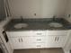 Bathroom vanity featuring double sinks, granite counters, and white cabinets at 14489 Se 38Th Ter, Summerfield, FL 34491