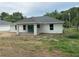 Rear exterior with sliding glass doors and a covered patio at 14489 Se 38Th Ter, Summerfield, FL 34491