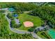 Aerial view of community recreation area, including a baseball field and playground at 14680 Yorkshire Run Dr, Orlando, FL 32828