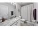 Well-lit bathroom with a marble countertop, white cabinets, and a shower-tub combination at 14680 Yorkshire Run Dr, Orlando, FL 32828
