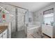 Elegant bathroom with a glass shower, soaking tub, and stylish marble accents at 14680 Yorkshire Run Dr, Orlando, FL 32828