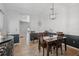 Cozy dining area with wood table set, stylish lighting, and classic wainscotting for an elegant touch at 14680 Yorkshire Run Dr, Orlando, FL 32828