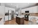 Well-equipped kitchen featuring stainless steel appliances, a center island, and ample storage space in white cabinetry at 14680 Yorkshire Run Dr, Orlando, FL 32828