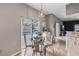 Bright kitchen nook with a glass-top table set and sliding doors leading to the backyard pool at 14680 Yorkshire Run Dr, Orlando, FL 32828