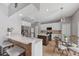 Bright kitchen featuring white cabinets, granite countertops, an island, and stainless steel appliances at 14680 Yorkshire Run Dr, Orlando, FL 32828