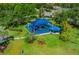 Aerial view of the neighborhood playground and picnic area with shade cover, lush landscaping, and nearby walking paths at 14680 Yorkshire Run Dr, Orlando, FL 32828