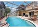 Stunning pool area with a screened enclosure, outdoor seating, and lush landscaping at 14680 Yorkshire Run Dr, Orlando, FL 32828