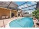 Screened-in pool area with lounge chairs and patio furniture, perfect for outdoor relaxation and entertaining at 14680 Yorkshire Run Dr, Orlando, FL 32828
