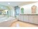 Large primary bathroom with bathtub, double vanity, and abundant natural light at 1477 Shadwell Cir, Lake Mary, FL 32746