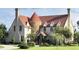 Charming estate featuring a stone turret, brick exterior, and clay tile roof at 1477 Shadwell Cir, Lake Mary, FL 32746