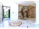 Elegant foyer featuring marble floors, a stone accent wall, and a wrought iron staircase leading to the second floor at 1477 Shadwell Cir, Lake Mary, FL 32746