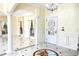 Elegant foyer showcasing marble floors, decorative columns, and a door with decorative glass at 1477 Shadwell Cir, Lake Mary, FL 32746