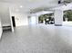 Spacious garage with epoxy flooring, white walls, and an open door revealing a golf cart parked outside at 1477 Shadwell Cir, Lake Mary, FL 32746