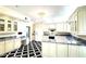 Well-lit kitchen with ample counter space, custom cabinets, and a stylish black-and-white floor at 1477 Shadwell Cir, Lake Mary, FL 32746