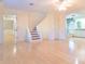 Spacious living room with hardwood floors, staircase, and access to the bathroom at 1477 Shadwell Cir, Lake Mary, FL 32746