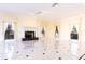 Spacious living room with a fireplace, large windows, and elegant marble flooring at 1477 Shadwell Cir, Lake Mary, FL 32746