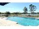 Inviting swimming pool overlooking lush landscaping and serene lake views, perfect for relaxation at 1477 Shadwell Cir, Lake Mary, FL 32746
