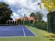 Estate with professionally maintained tennis court surrounded by an ornamental iron fence at 1477 Shadwell Cir, Lake Mary, FL 32746
