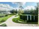 Aerial view of tennis courts next to professionally landscaped estate at 1477 Shadwell Cir, Lake Mary, FL 32746