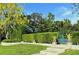 Professionally maintained tennis court features lush landscaping, and a verdant hedge at 1477 Shadwell Cir, Lake Mary, FL 32746