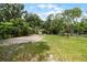 A large grassy backyard with mature trees offers a tranquil outdoor space and features a storage shed at 1502 S Summerlin Ave, Sanford, FL 32771