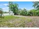 A spacious yard, partially grassed, surrounding the building with storage shed and mature trees at 1502 S Summerlin Ave, Sanford, FL 32771