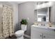 Cozy bathroom with updated lighting and neutral colored shower curtain at 1502 S Summerlin Ave, Sanford, FL 32771