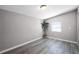 Bright bedroom with gray walls and modern decor with large windows and gray floors at 1502 S Summerlin Ave, Sanford, FL 32771