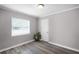 Bedroom with light gray walls, white trim, and modern vinyl plank flooring at 1502 S Summerlin Ave, Sanford, FL 32771