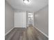 Spacious bedroom features wood-look floors, a closet, and an ensuite bathroom at 1502 S Summerlin Ave, Sanford, FL 32771