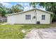 Rear exterior showing the side entrance, windows, and some grass space around the perimeter at 1502 S Summerlin Ave, Sanford, FL 32771