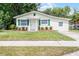Beautiful single-story home with manicured lawn, fresh paint, and eye-catching green shutters at 1502 S Summerlin Ave, Sanford, FL 32771