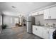 Open concept living room and kitchen with stainless steel appliances and modern accents at 1502 S Summerlin Ave, Sanford, FL 32771